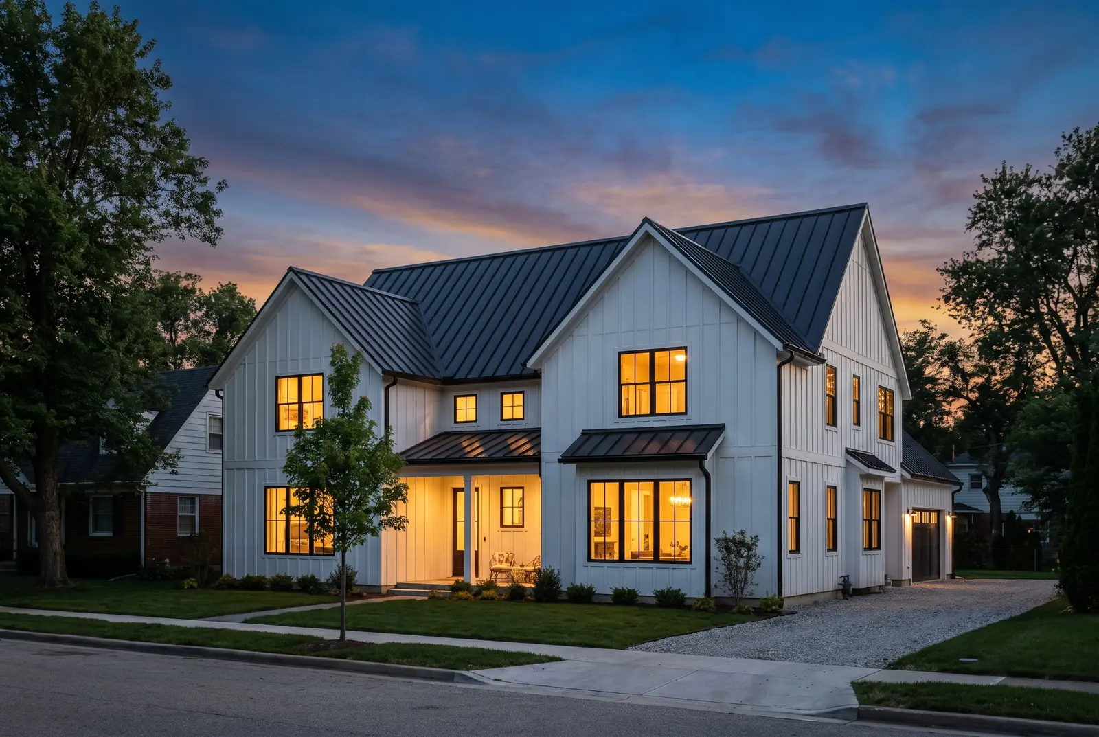Modern farmhouse-style new home at blue hour with a standing-seam metal roof (illustration) Modern farmhouse-style new home at blue hour with a standing-seam metal roof (illustration)