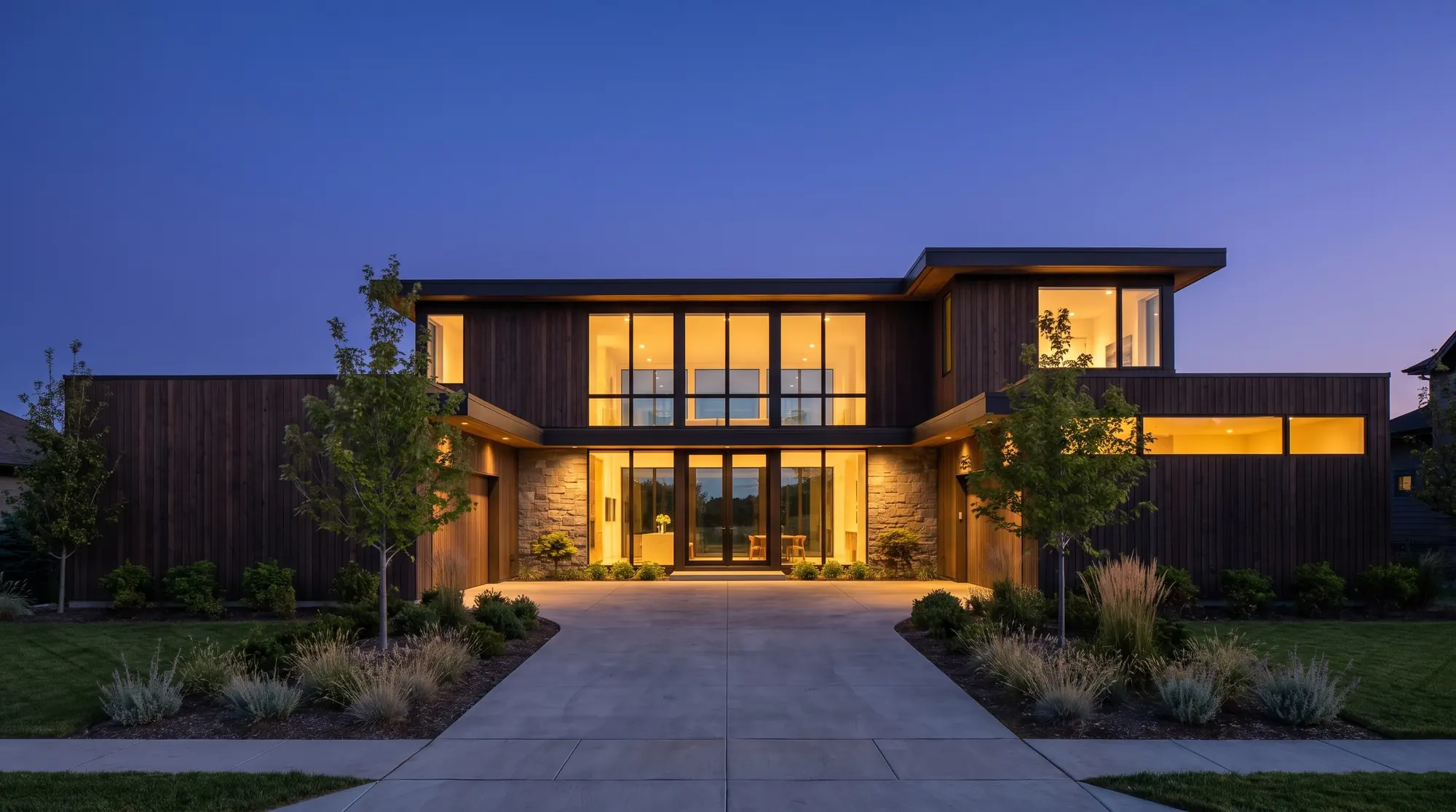 Modern single-family home at dusk with warm light in the windows (illustration)